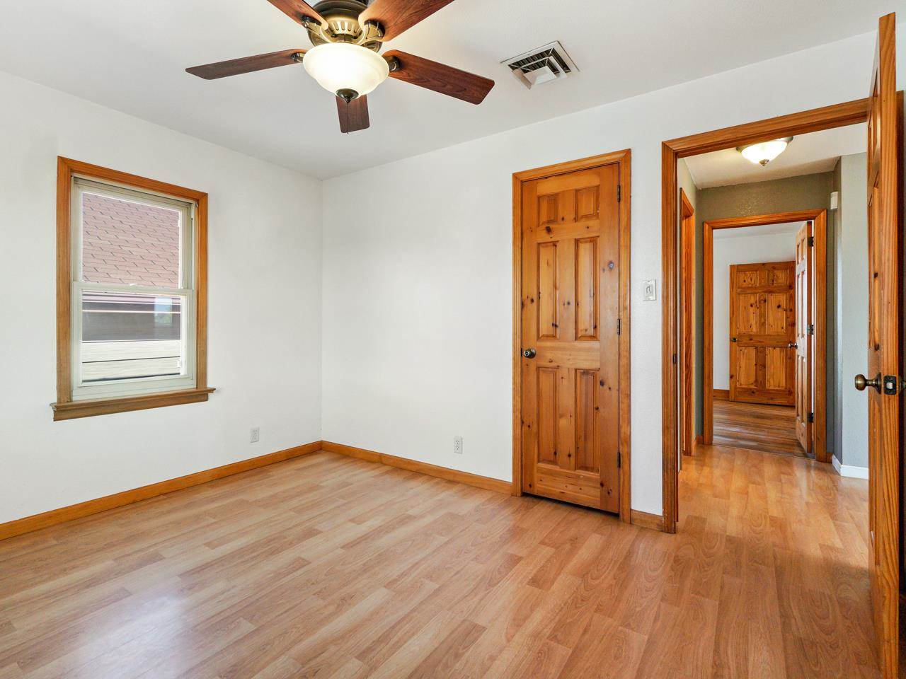 2278 H Road Grand Junction, CO 81505 - Photo 14 of 38 an empty room with wooden floor chandelier fan and windows