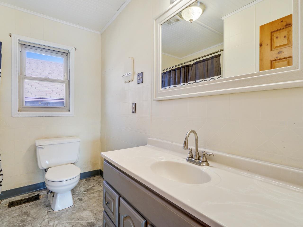 2278 H Road Grand Junction, CO 81505 - Photo 15 of 38 a bathroom with a toilet sink and mirror