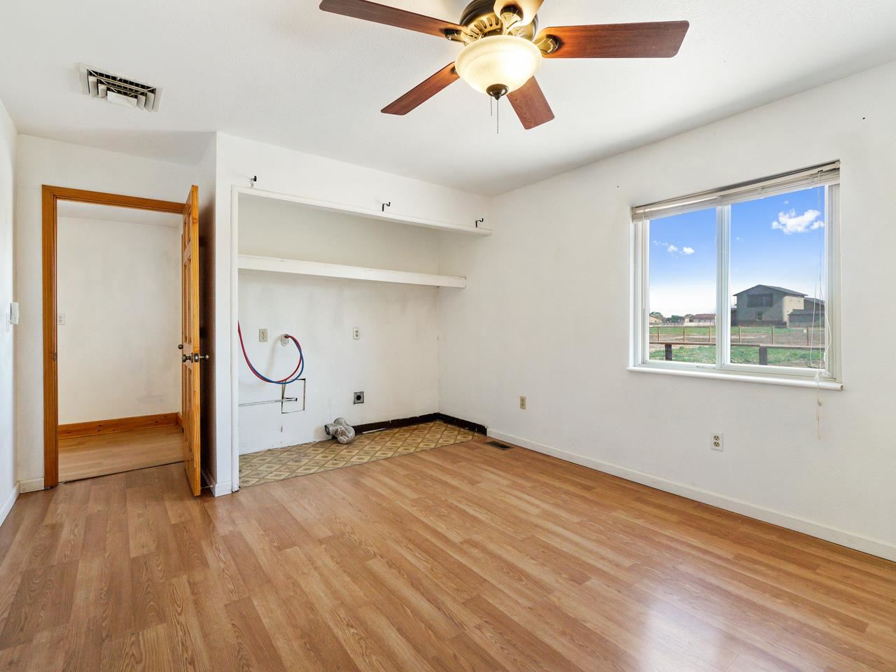 2278 H Road Grand Junction, CO 81505 - Photo 19 of 38 an empty room with wooden floor closet and windows