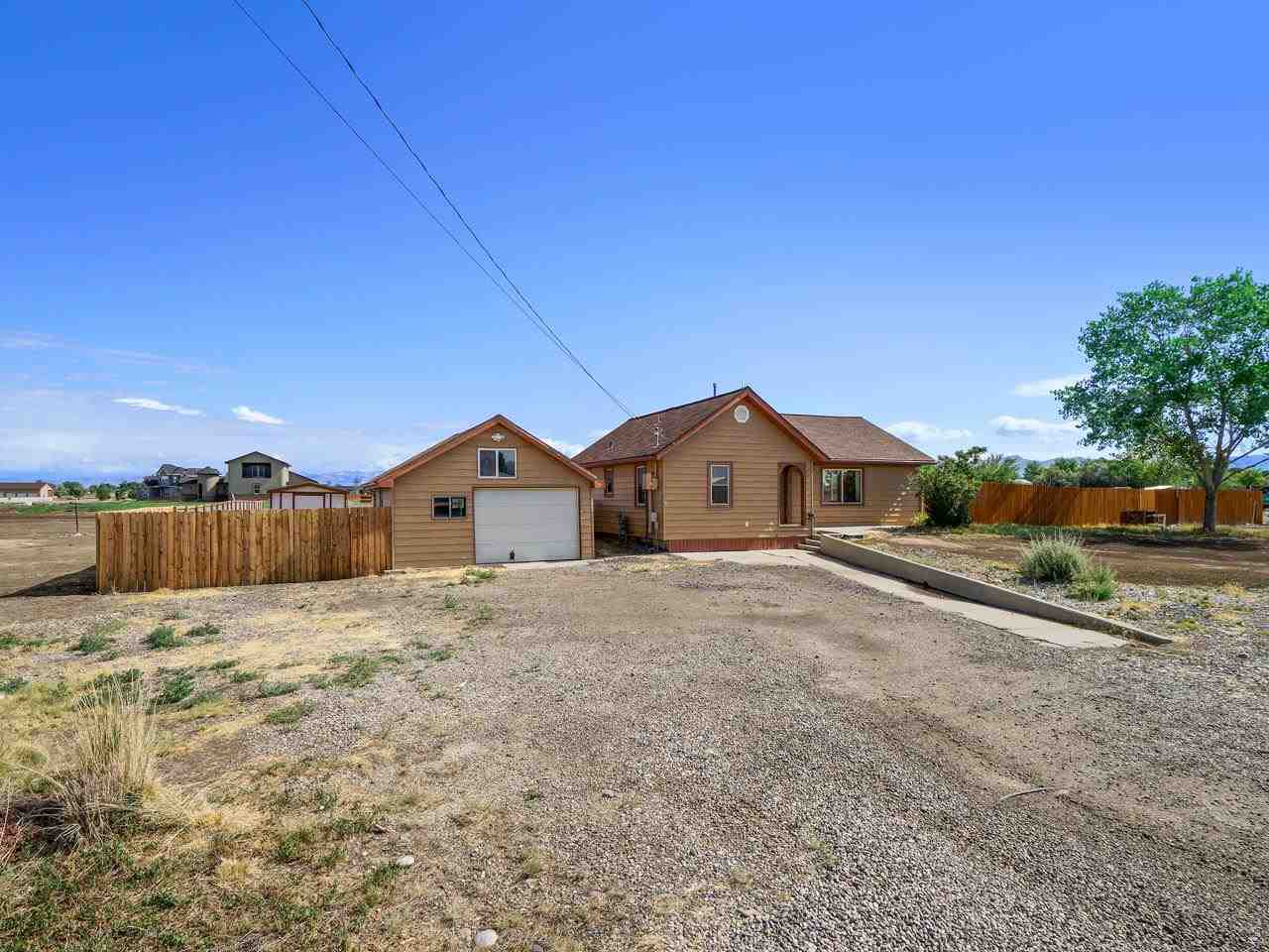 2278 H Road Grand Junction, CO 81505 - Photo 21 of 38 a big house with a big yard and large tree