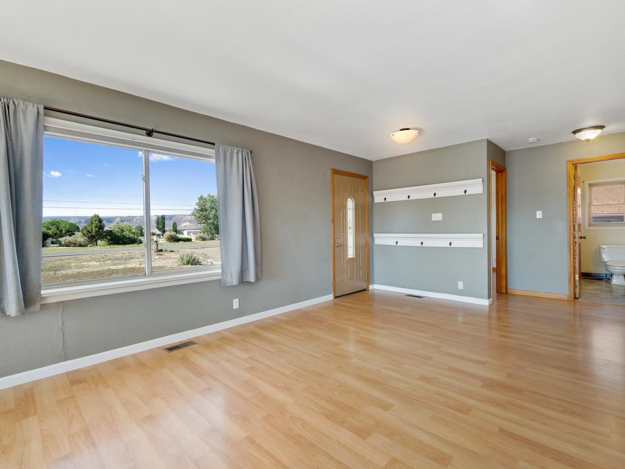 2278 H Road Grand Junction, CO 81505 - Photo 5 of 38 a view of an empty room with a window and wooden floor