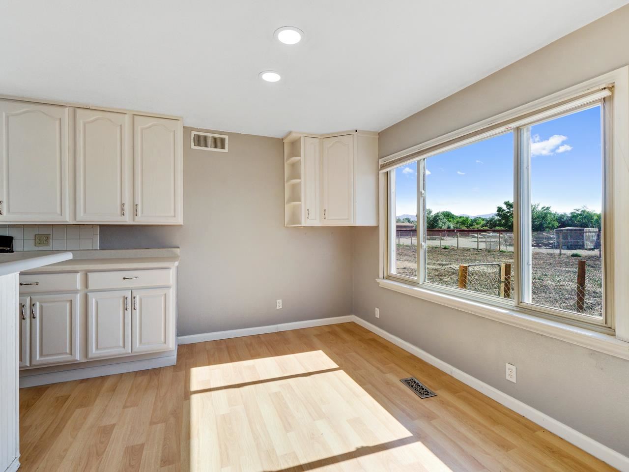 2278 H Road Grand Junction, CO 81505 - Photo 9 of 38 a view of a kitchen with wooden floor and cabinets