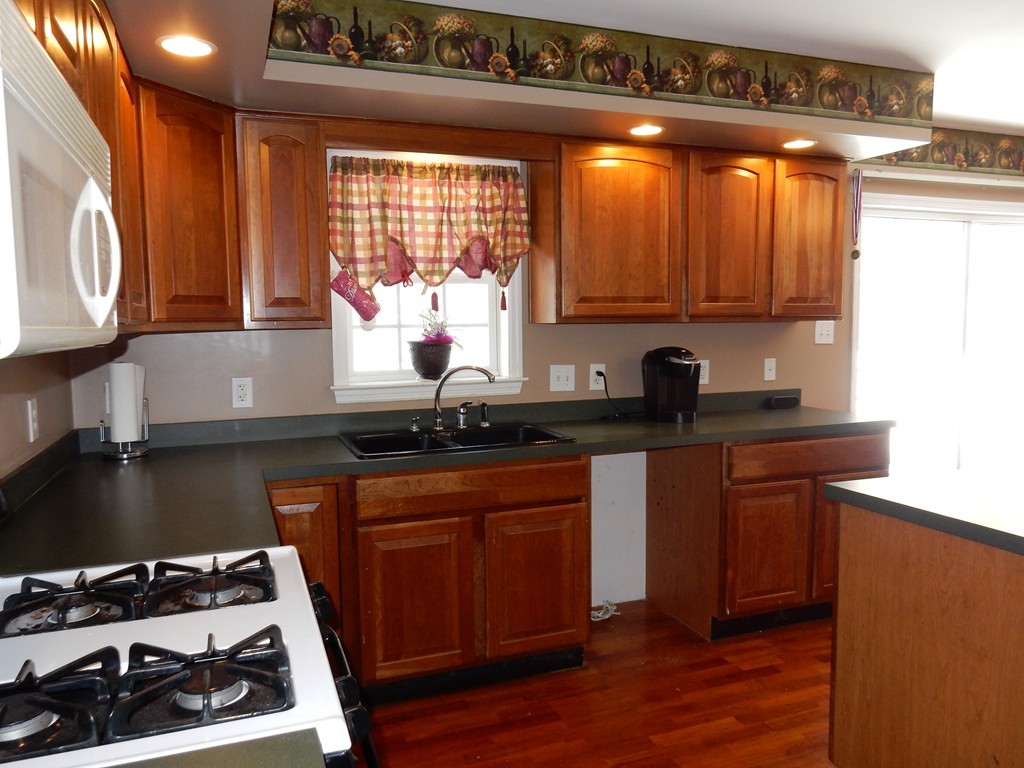 10 Cobb Hill Road Phillipston, MA 01331 - Photo 3 of 25 a kitchen with granite countertop a stove a sink and a microwave