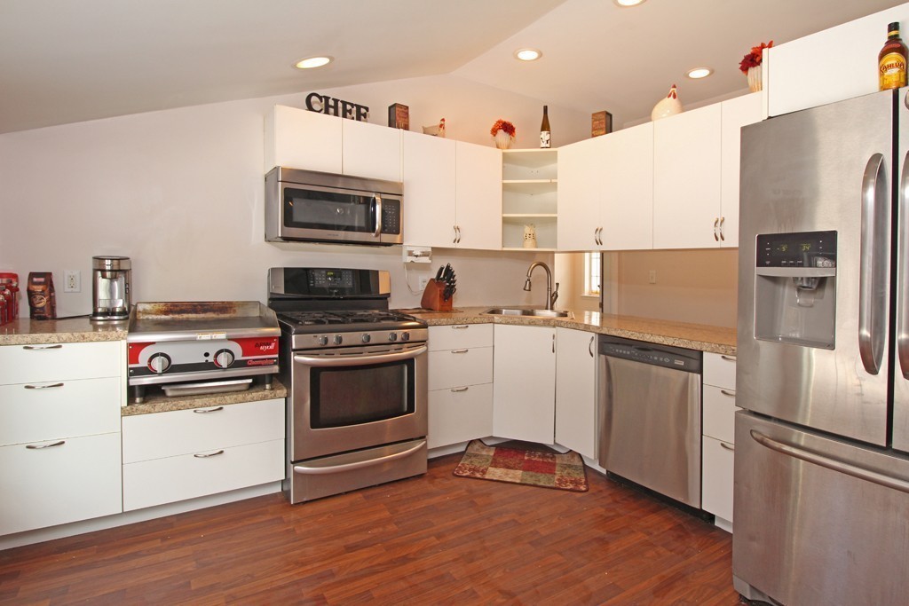 10 Cobb Hill Road Phillipston, MA 01331 - Photo 10 of 25 a kitchen with stainless steel appliances white cabinets and wooden floor