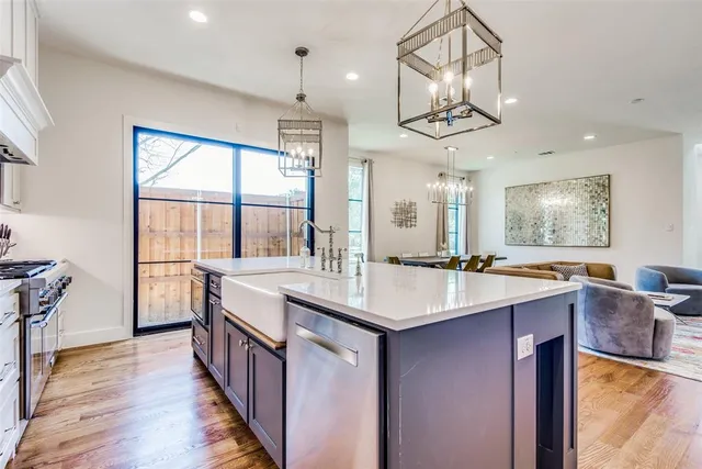 a kitchen with a sink stove top oven and refrigerator