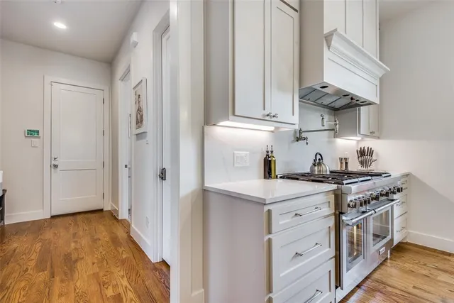 a kitchen with stainless steel appliances granite countertop a stove and a refrigerator