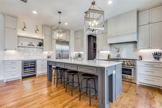 a kitchen with granite countertop a stove a table and chairs in it