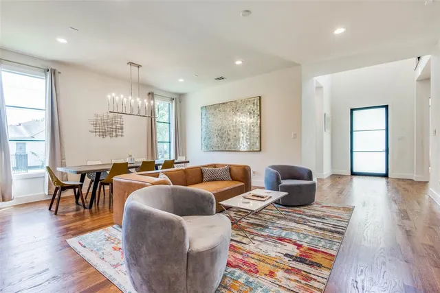 a living room with lots of furniture and a wooden floor