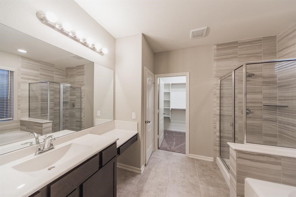 3219 Montclair Orchard Trace Spring, TX 77386 - Photo 15 of 27 a bathroom with a double vanity sink and a mirror