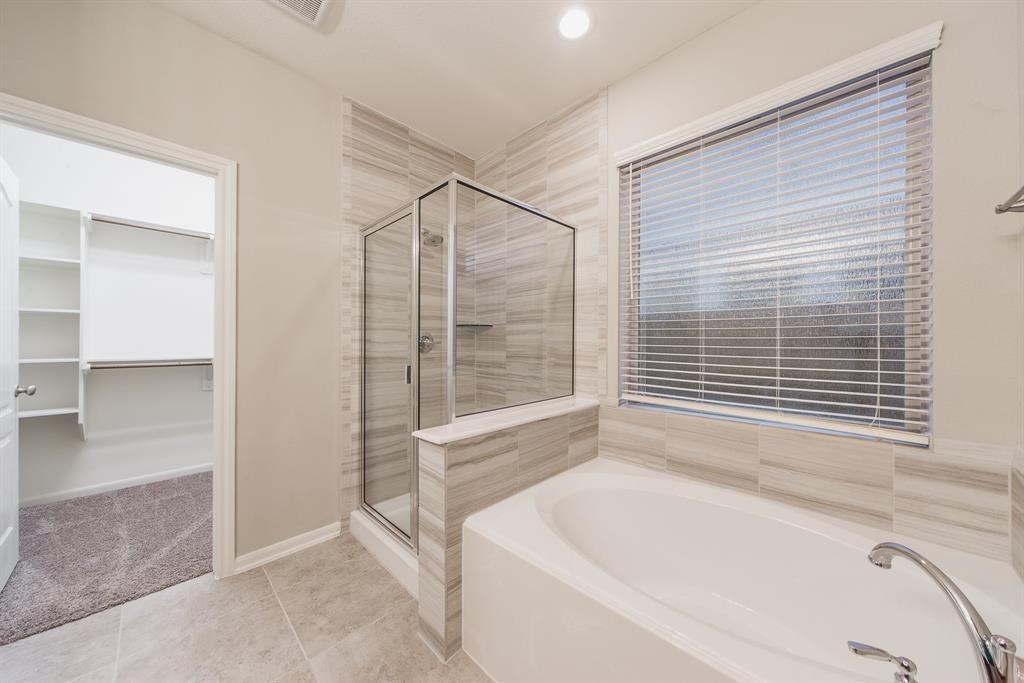 3219 Montclair Orchard Trace Spring, TX 77386 - Photo 16 of 27 a bathroom with a bathtub and a shower
