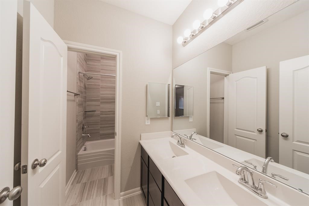 3219 Montclair Orchard Trace Spring, TX 77386 - Photo 23 of 27 a bathroom with a double vanity sink mirror and shower