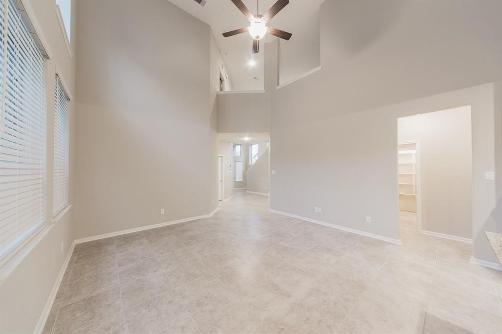 3219 Montclair Orchard Trace Spring, TX 77386 - Photo 8 of 27 an empty room with a ceiling fan and a window