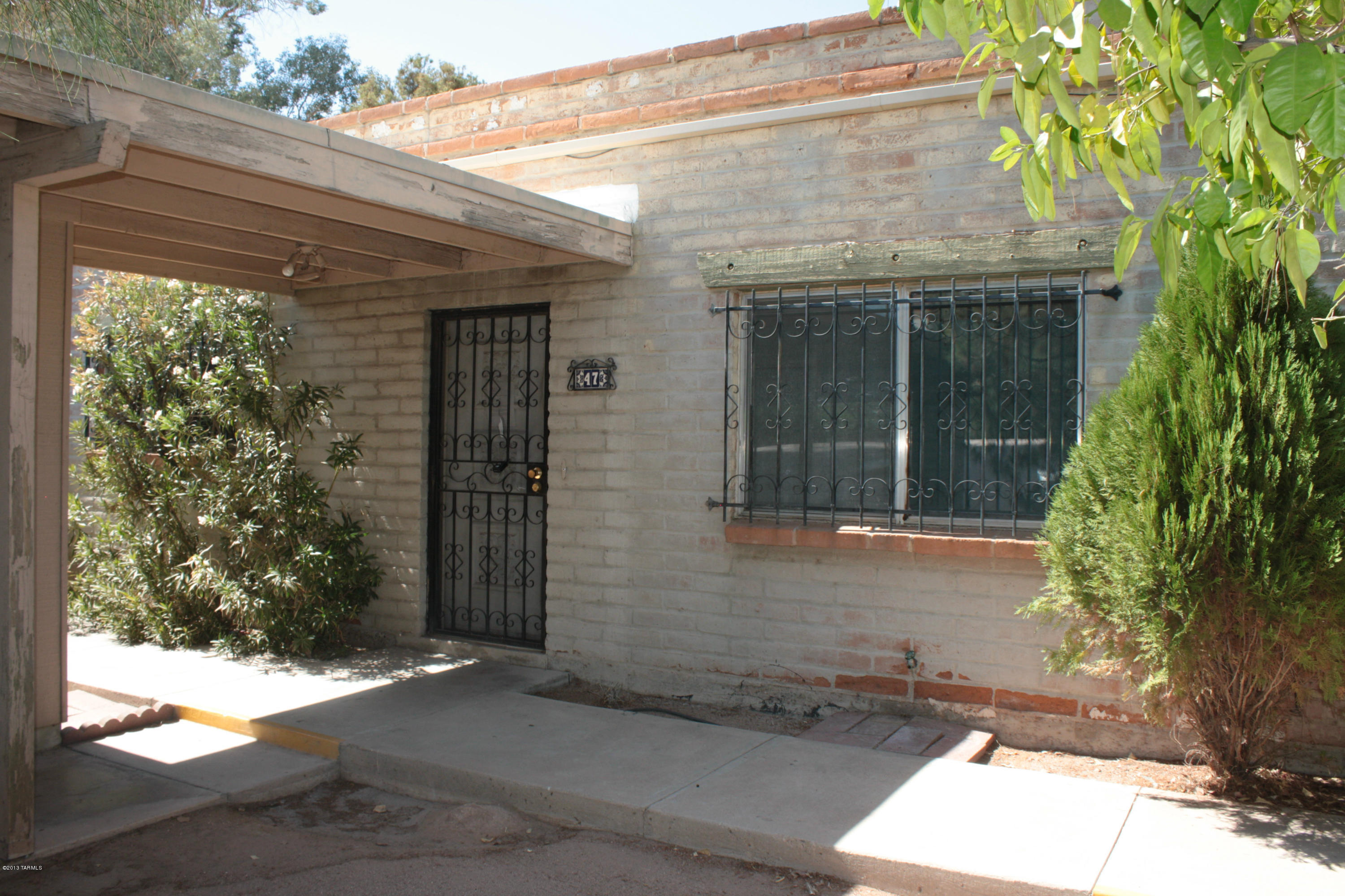 47 East Pastime Road Tucson, AZ 85705 - Photo 1 of 16 a front view of a house with a yard