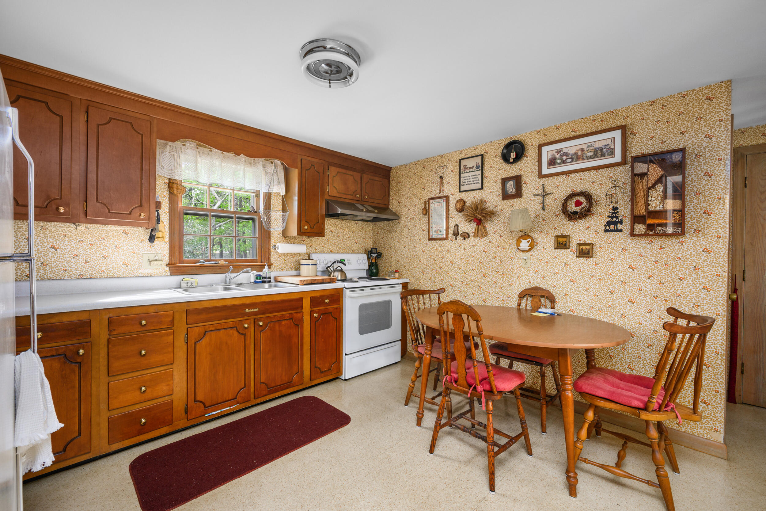 59 Beverly Road West Yarmouth, MA 02673 - Photo 20 of 33 a open kitchen with stainless steel appliances granite countertop a sink a stove a dining table and chairs with wooden floor