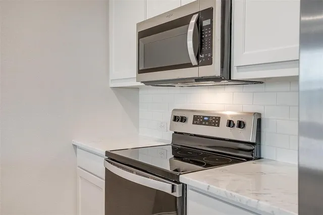a stove top oven sitting inside of a kitchen