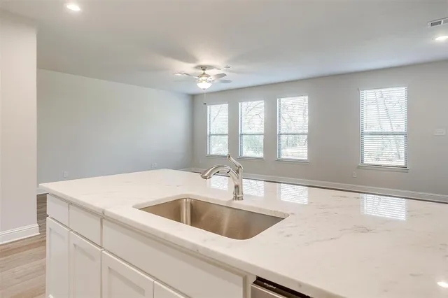 a view white cabinets and a sink