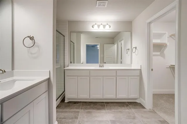 a bathroom with a sink vanity and a mirror