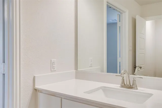 a bathroom with a sink and a large mirror