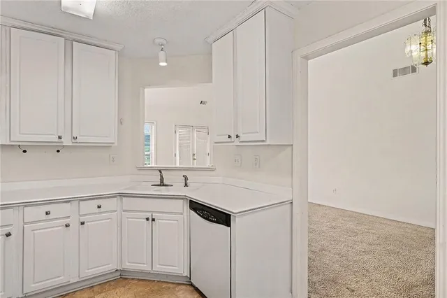 a kitchen with white cabinets