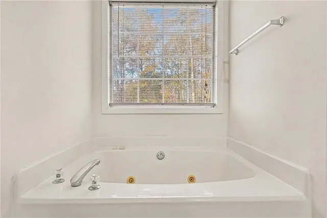 a bathroom with bathtub and window