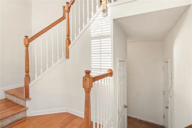 a view of entryway with wooden floor and stairs