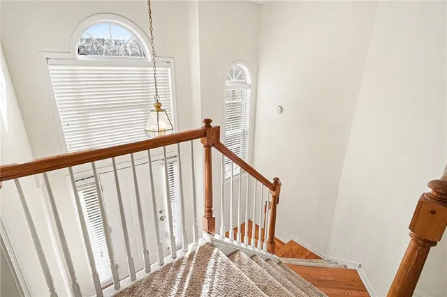 a view of staircase with rug