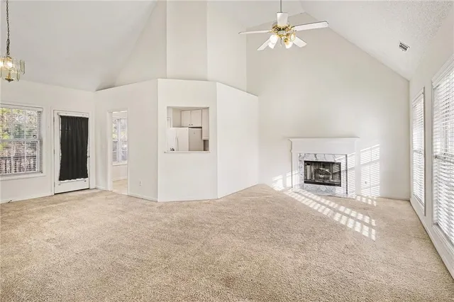 an empty room with fireplace and windows