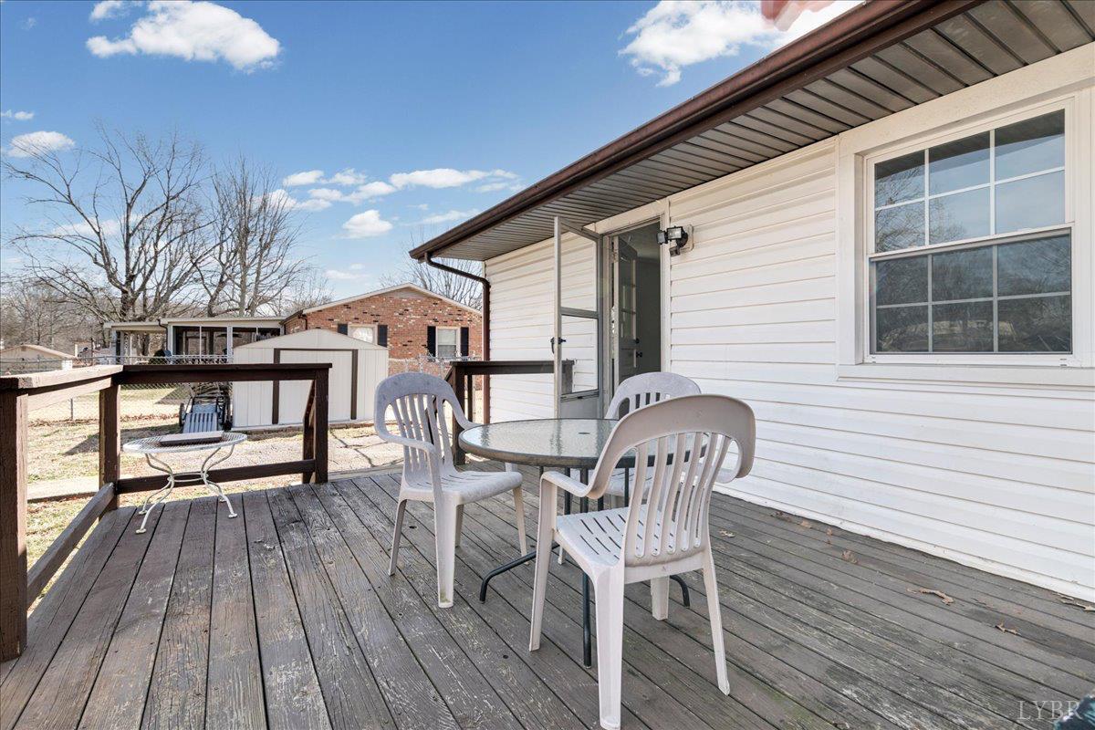 813 Doss Road Concord, VA 24538 - Photo 28 of 31 a patio with wooden floor and outdoor seating