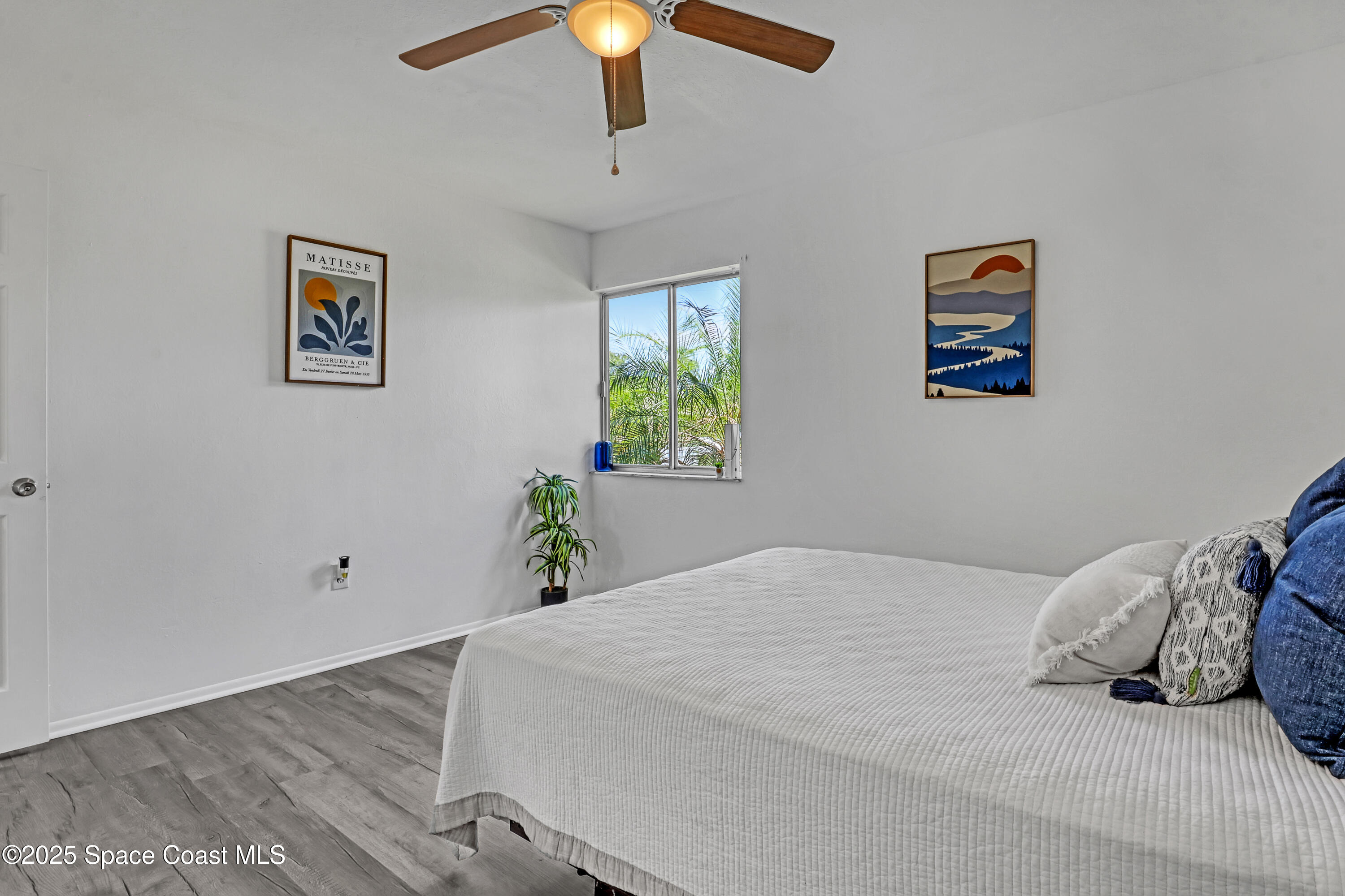 261 Chase Road Cocoa, FL 32927 - Photo 12 of 26 a bedroom with a bed and a painting on the wall