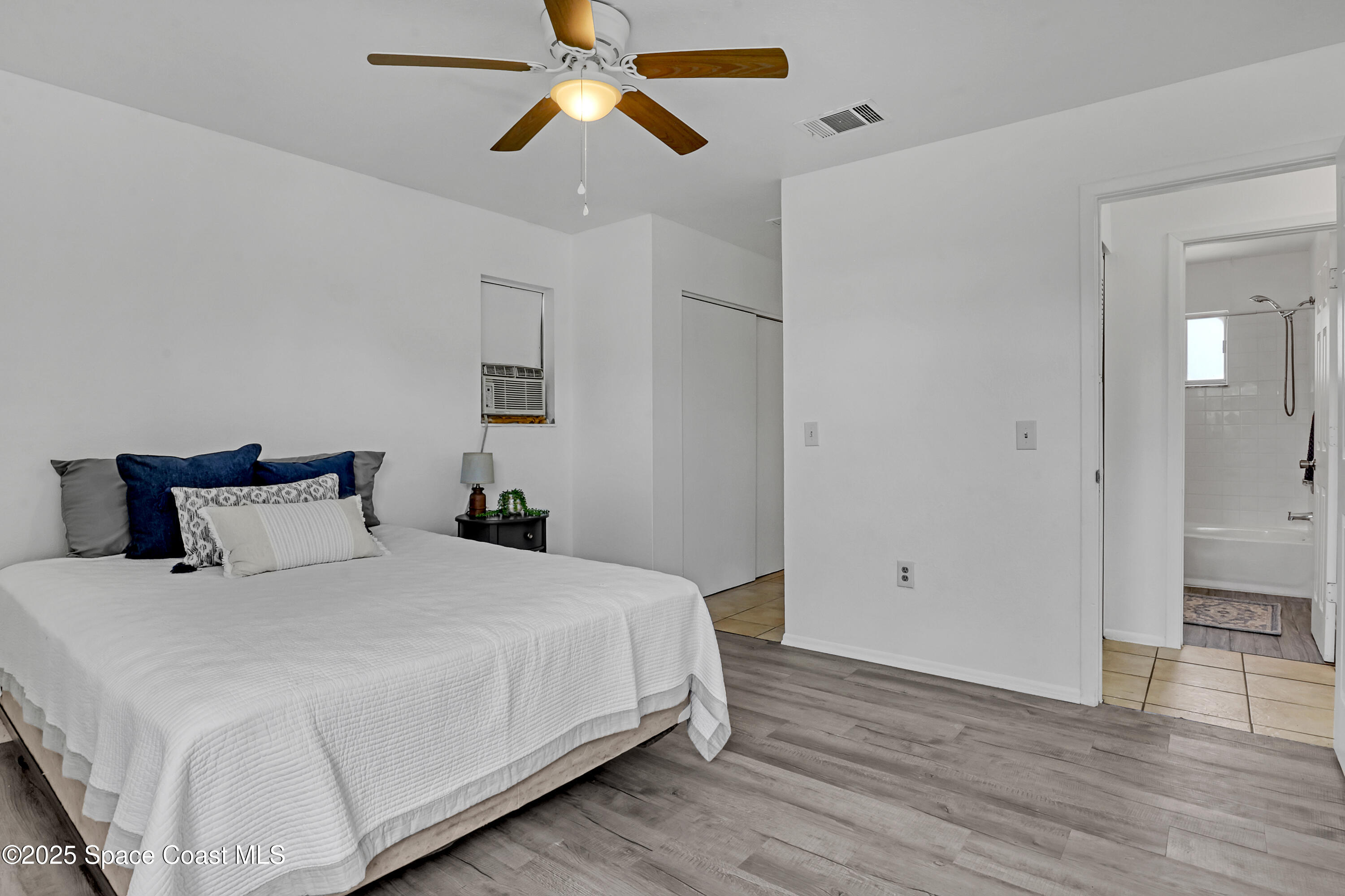 261 Chase Road Cocoa, FL 32927 - Photo 13 of 26 a bedroom with a bed and wooden floor