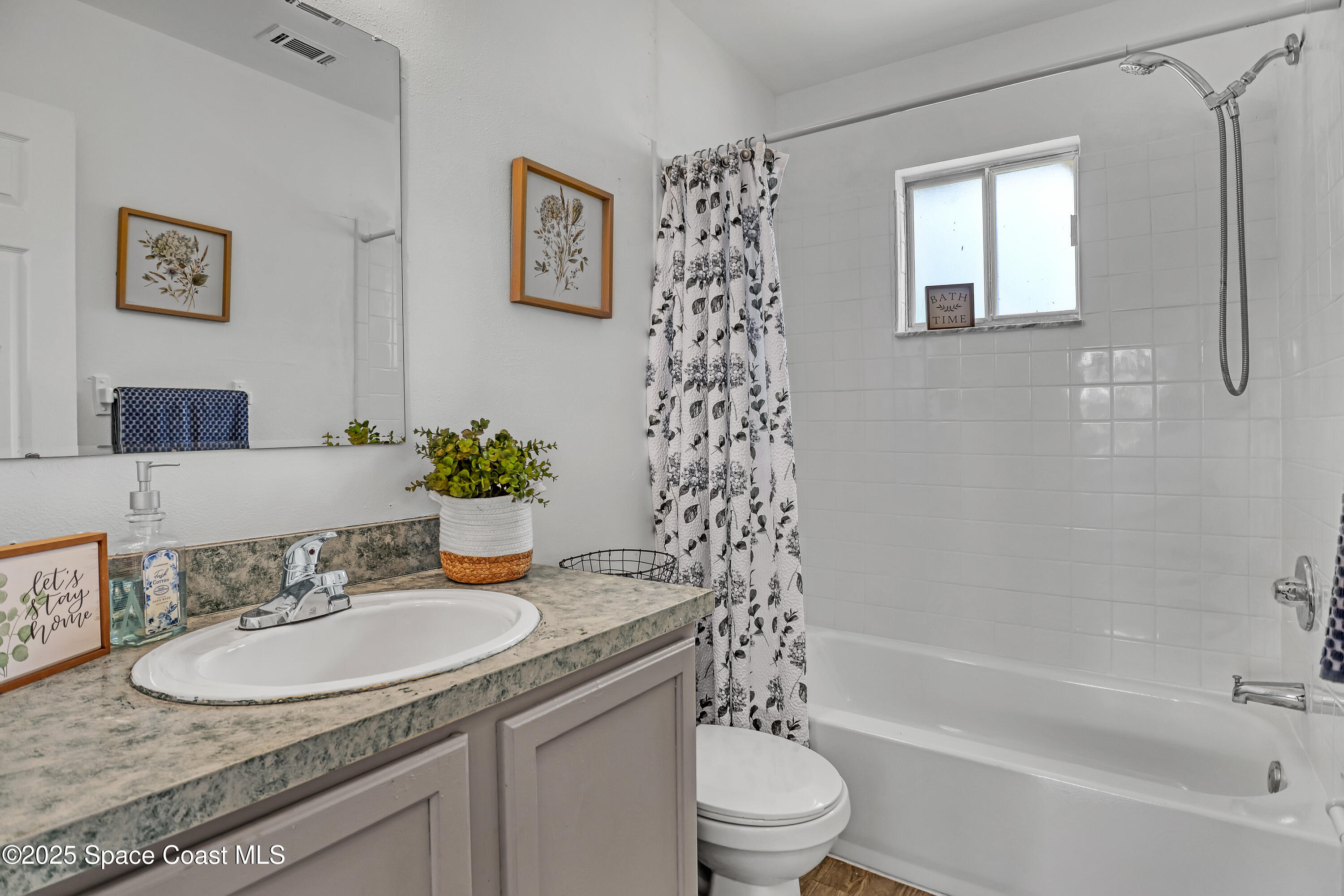 261 Chase Road Cocoa, FL 32927 - Photo 14 of 26 a bathroom with a granite countertop sink toilet and a bathtub