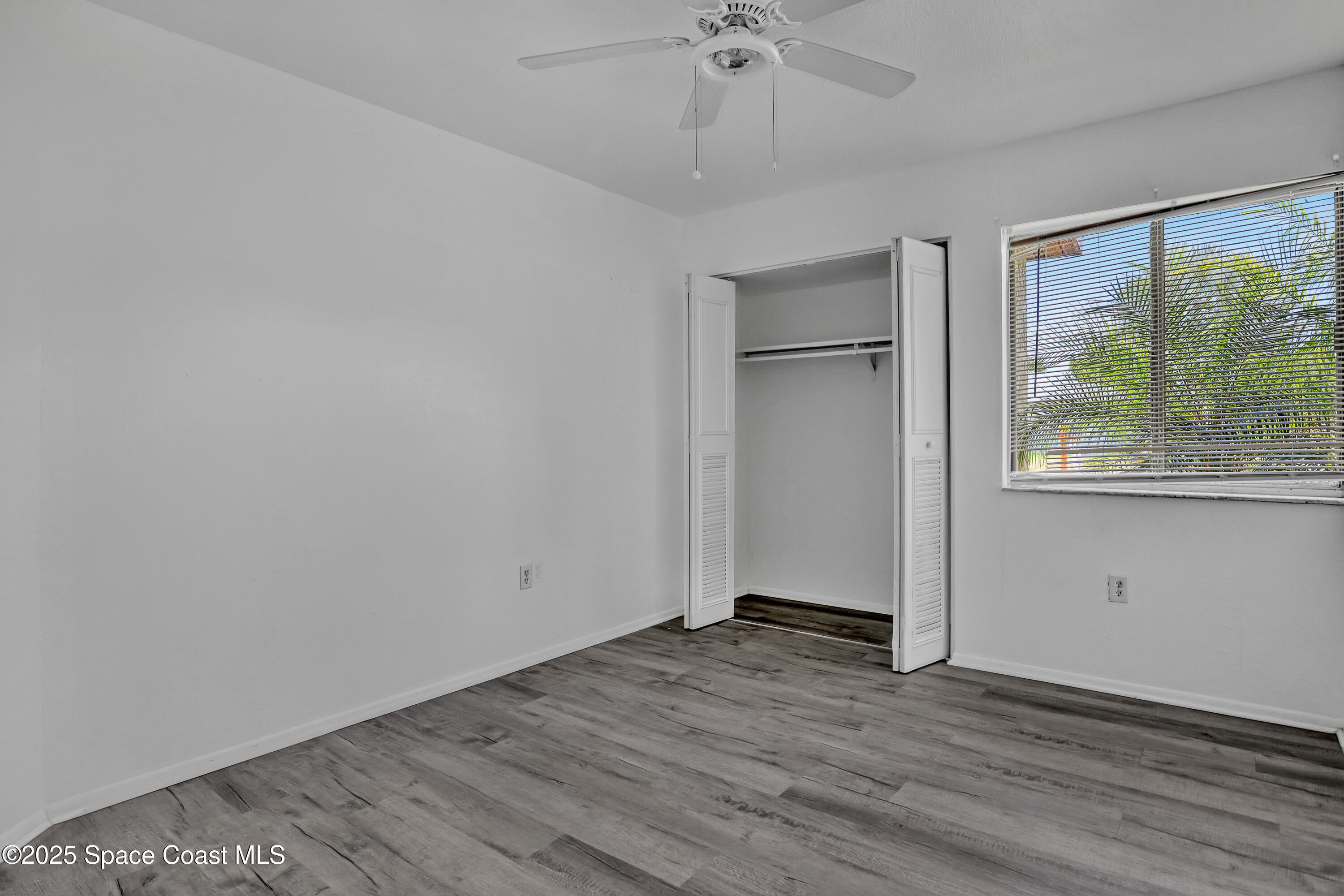 261 Chase Road Cocoa, FL 32927 - Photo 20 of 26 wooden floor in an empty room with a window