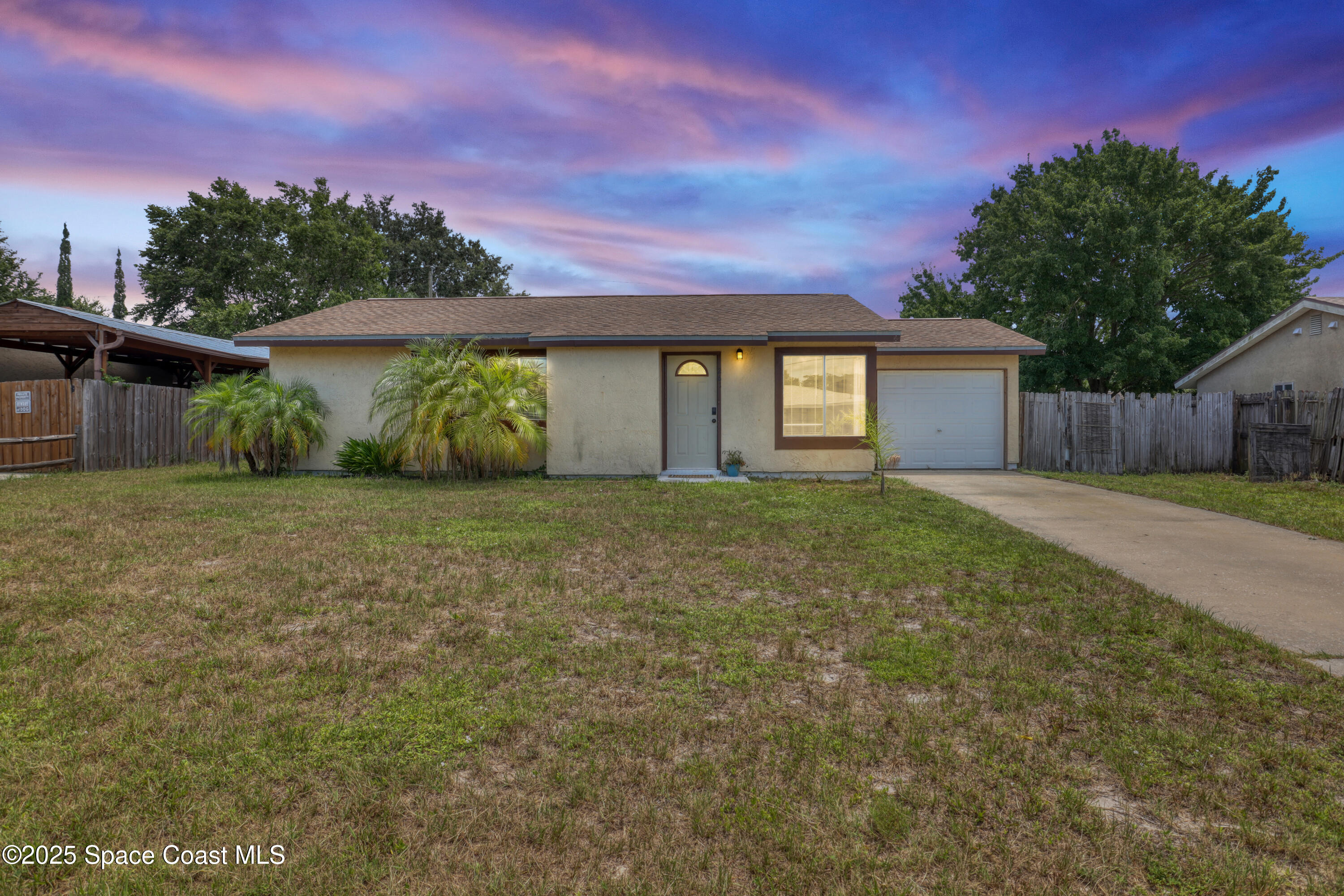 261 Chase Road Cocoa, FL 32927 - Photo 26 of 26 a front view of a house with a yard and garage