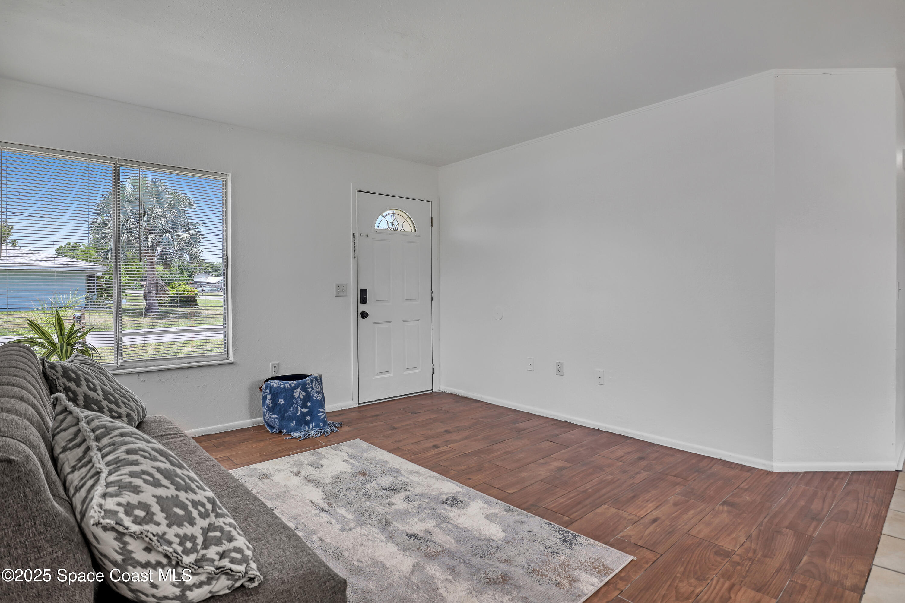 261 Chase Road Cocoa, FL 32927 - Photo 4 of 26 a bedroom with a bed and a window