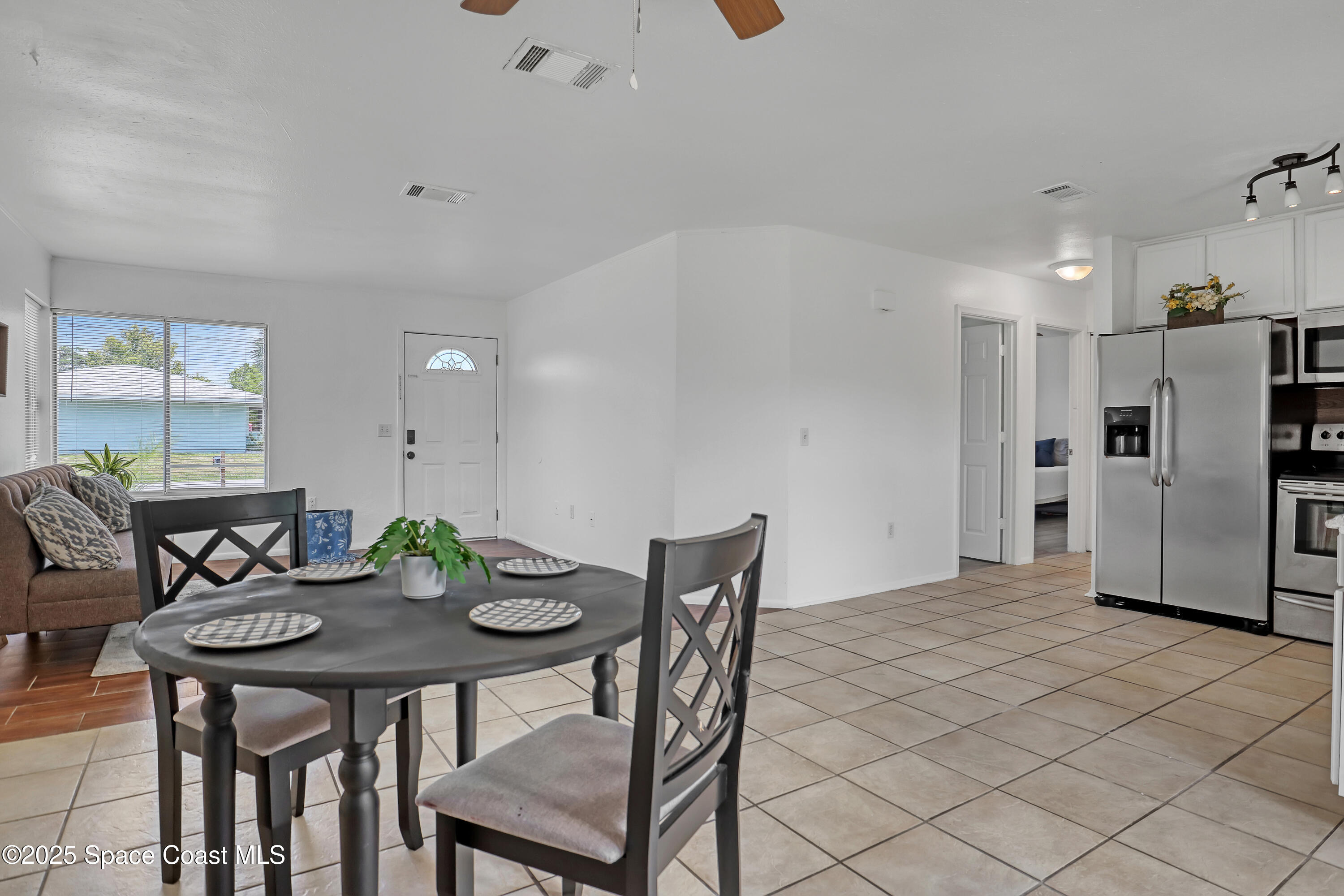 261 Chase Road Cocoa, FL 32927 - Photo 6 of 26 a kitchen with stainless steel appliances kitchen island granite countertop a dining table and chairs