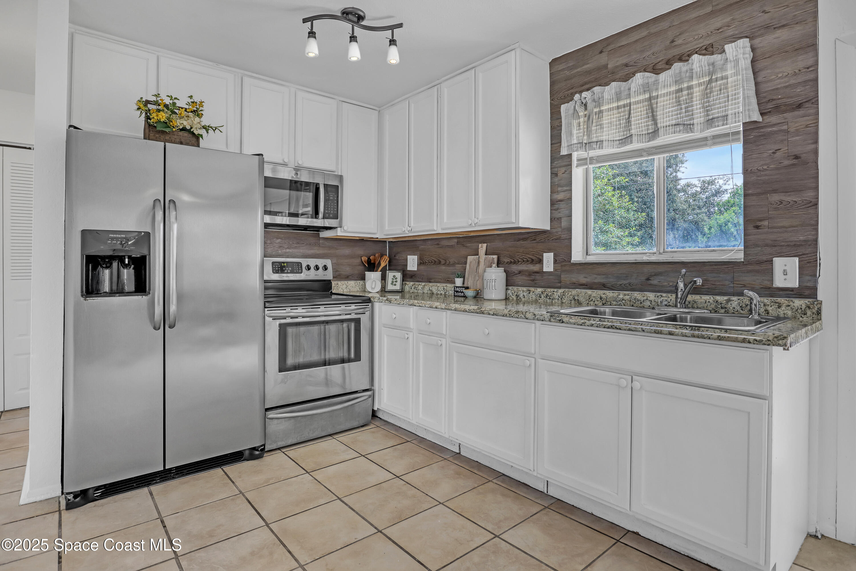 261 Chase Road Cocoa, FL 32927 - Photo 10 of 26 a kitchen with stainless steel appliances a refrigerator sink and microwave