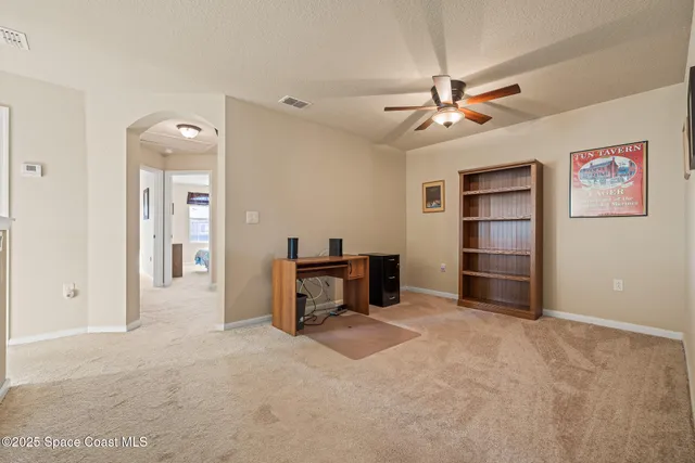 wooden floor and ceiling fan in a room