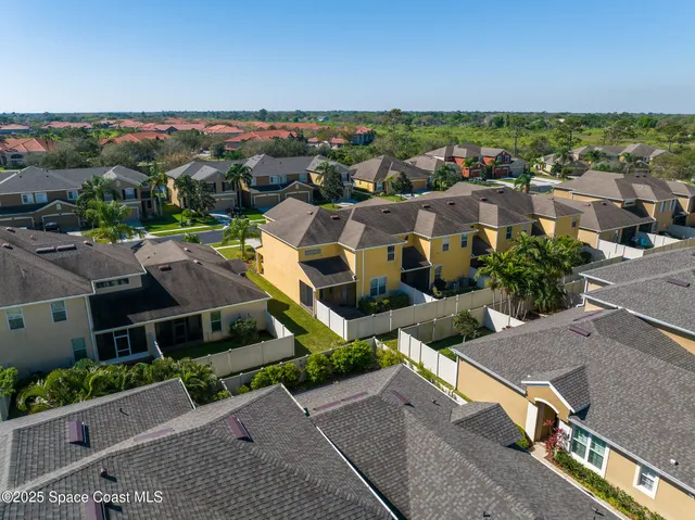 an aerial view of residential houses with outdoor space