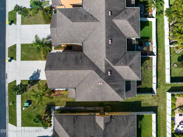 an aerial view of a house with a yard