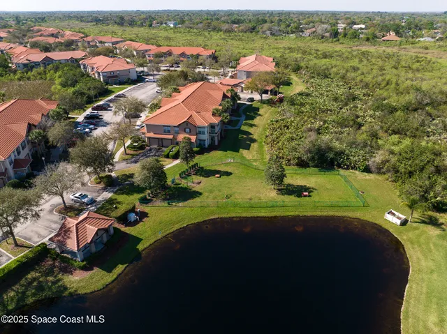 an aerial view of residential houses with outdoor space and river