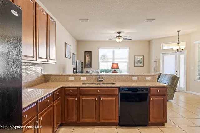 a kitchen with a sink a counter space and cabinets