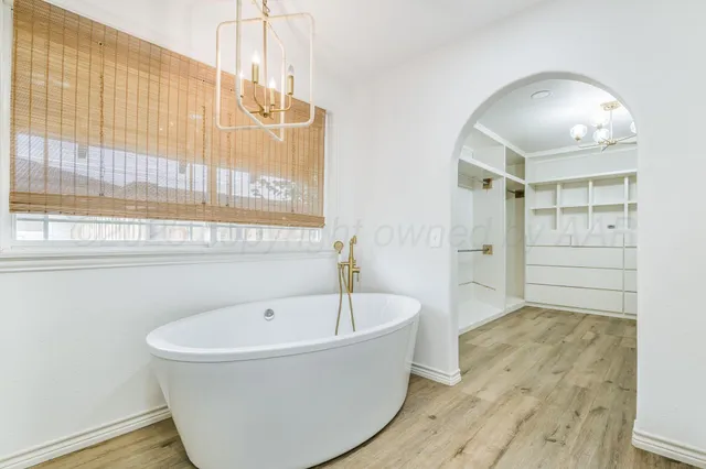 a bathroom with a bathtub and shower