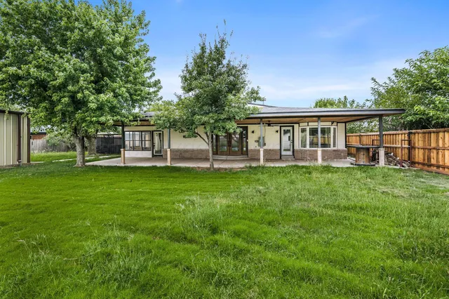 a view of a house with a backyard porch and sitting area