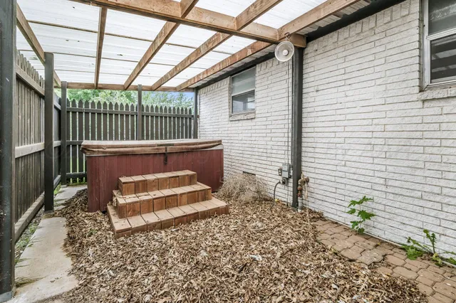 a view of a backyard with a table and chair