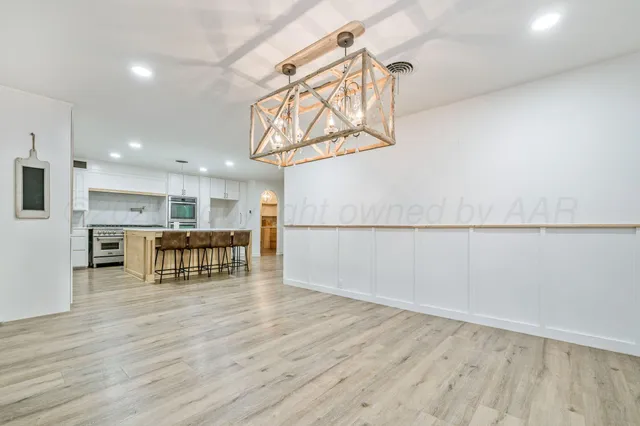 a view of a kitchen with furniture and wooden floor