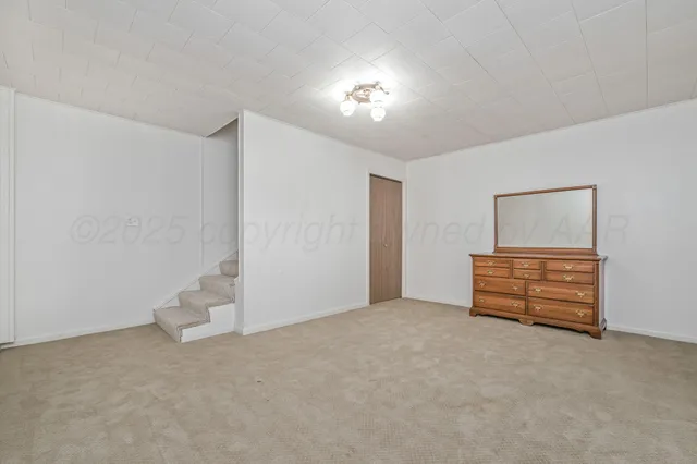 a view of an empty room with a fan