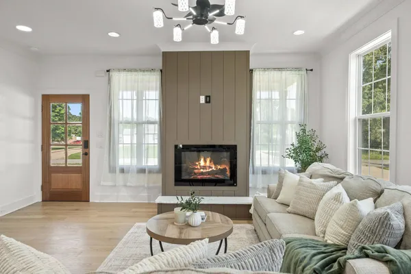 a living room with furniture and a fireplace