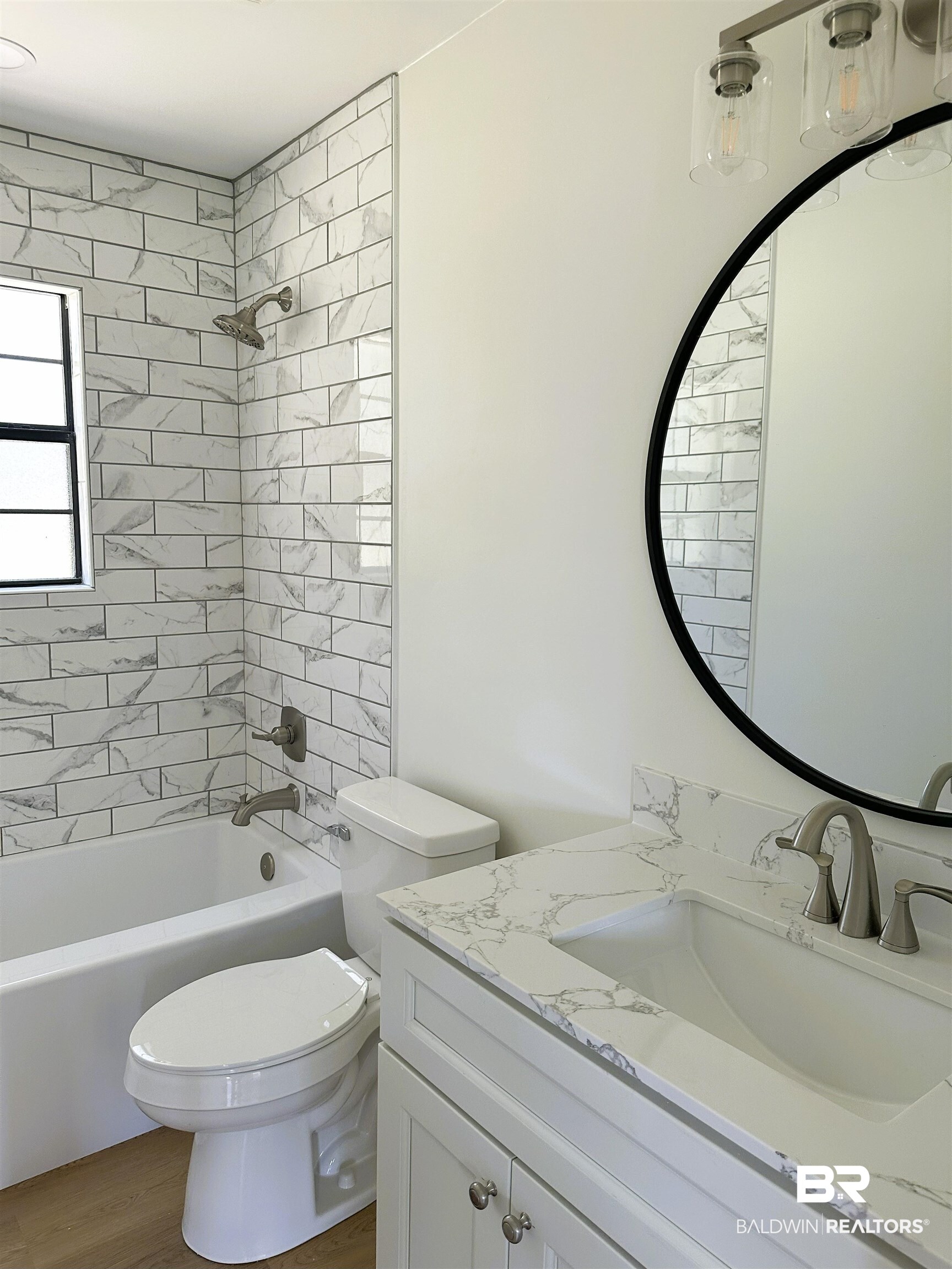 701 McRae Street Atmore, AL 36502 - Photo 7 of 11 Full bath featuring tub / shower combination, vanity, and wood finished floors