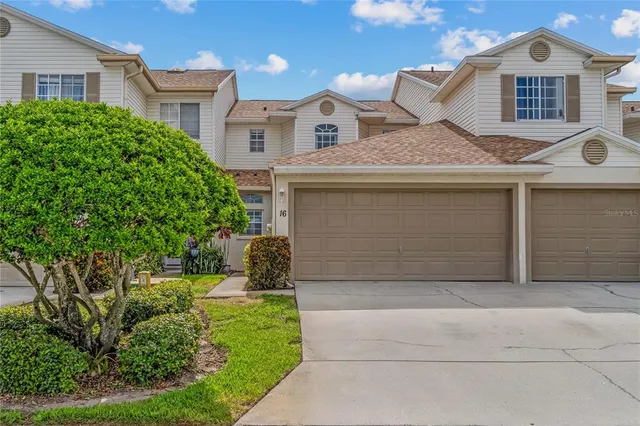a front view of a house with a yard and a garage