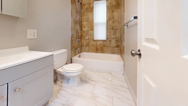 a bathroom with a toilet a sink and bathtub